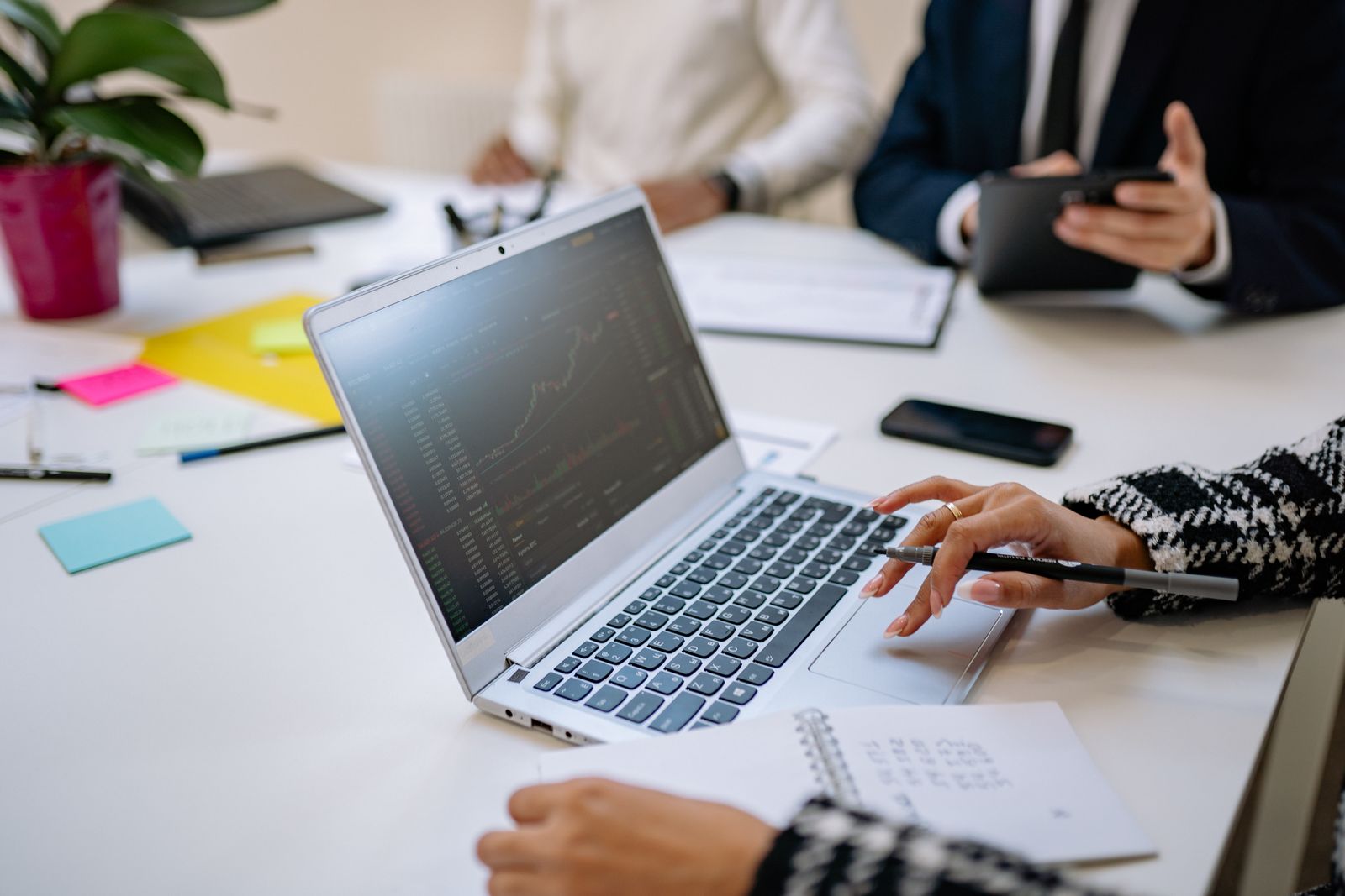 Geschäftsleute analysieren gemeinsam Daten an einem Laptop
